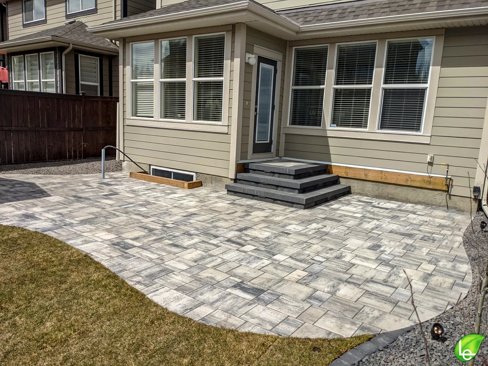 Large patterned paving-stone patio and new entry steps